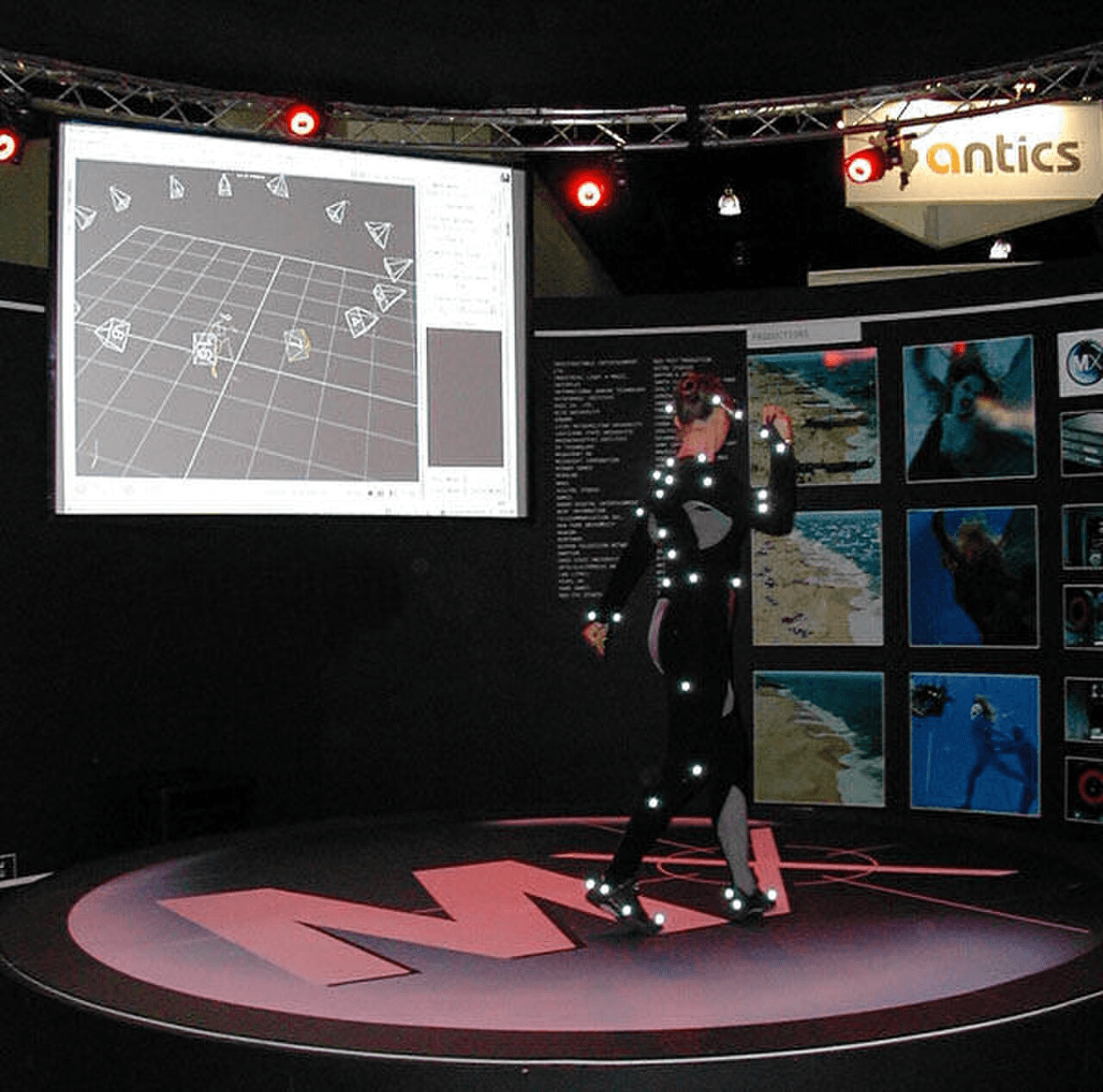Performer in a motion capture studio with marker suit